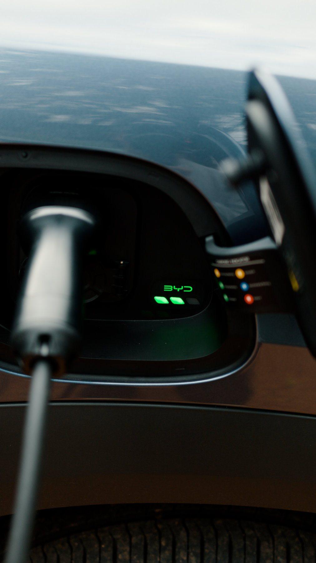 Electric vehicle plugged in and charging at home