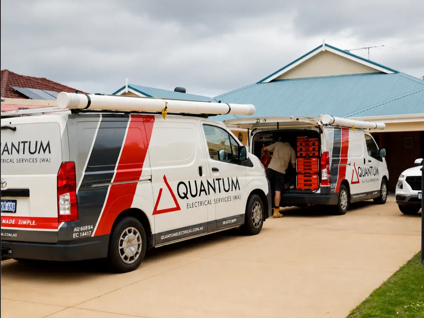 Branded Quantum Electrical Services van parked outside a commercial building