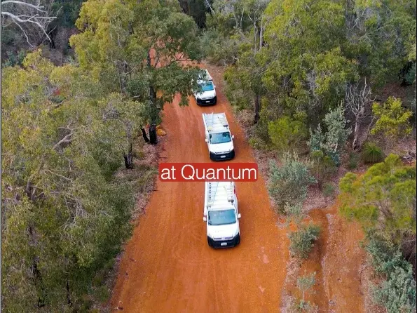Aerial view of a Quantum van parked on a tree-lined Perth Hills driveway